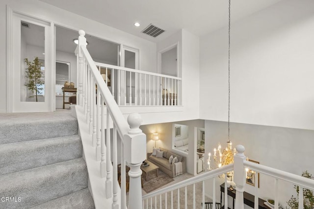 stairs featuring recessed lighting, visible vents, a notable chandelier, and carpet flooring