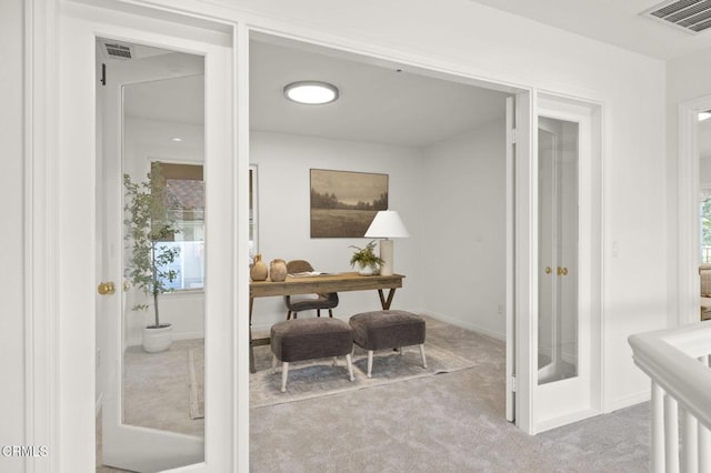 office area with baseboards, french doors, visible vents, and light colored carpet