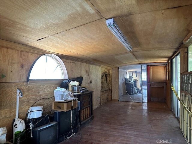 interior space featuring wooden walls, wood ceiling, and wood finished floors