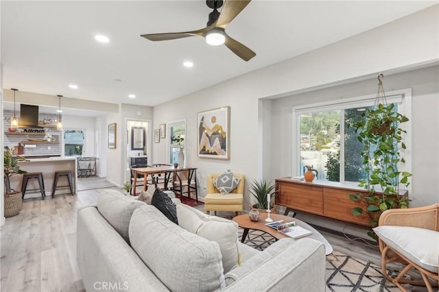 living room featuring recessed lighting, light wood finished floors, and ceiling fan