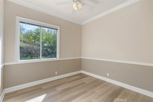 unfurnished room featuring light wood-type flooring, crown molding, baseboards, and ceiling fan