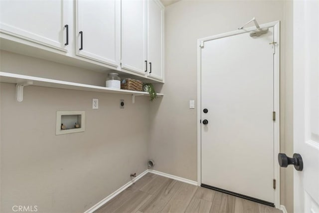 laundry room featuring hookup for a washing machine, baseboards, light wood-type flooring, cabinet space, and electric dryer hookup