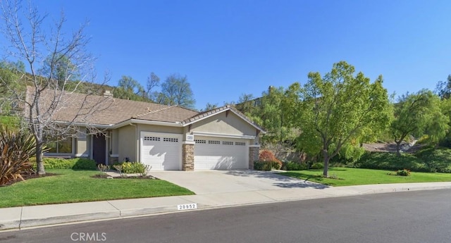 view of front of property featuring a garage, concrete driveway, stone siding, a front lawn, and stucco siding