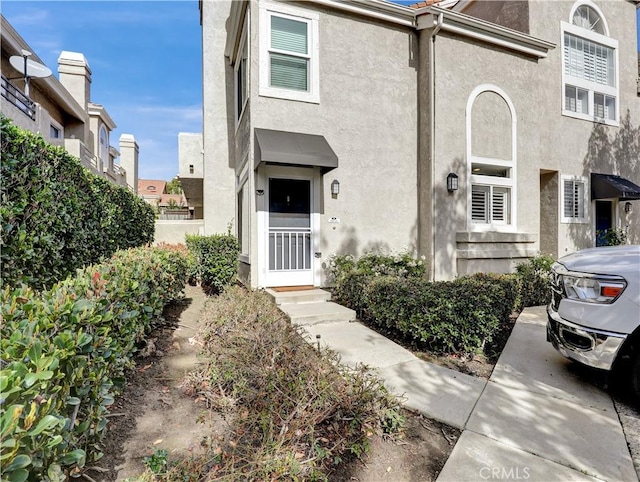 doorway to property with stucco siding