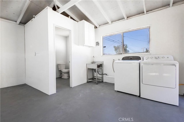 clothes washing area with laundry area, independent washer and dryer, and a sink