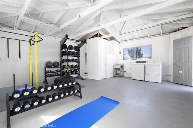 interior space featuring a garage, vaulted ceiling, and washer and dryer