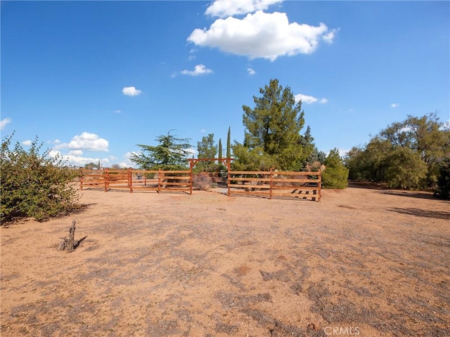 view of yard featuring a rural view and fence