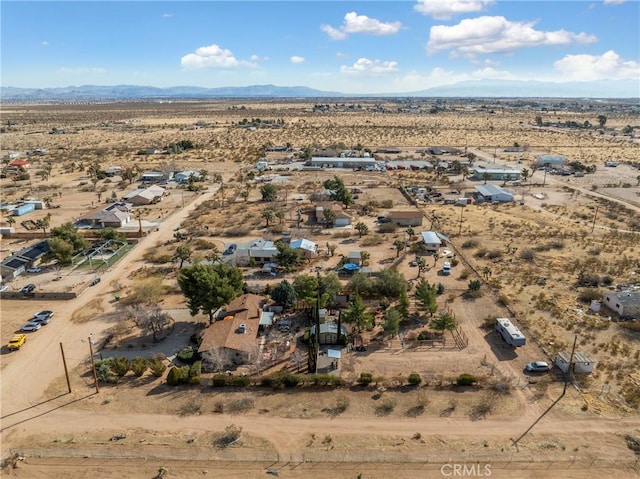 birds eye view of property with a mountain view and a desert view