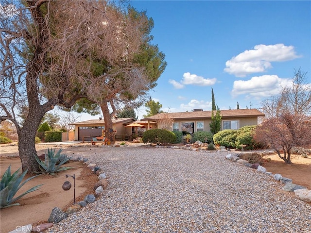 single story home with a garage and stucco siding