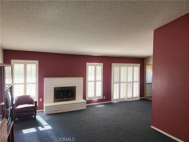 living area with dark colored carpet, a brick fireplace, a textured ceiling, and baseboards