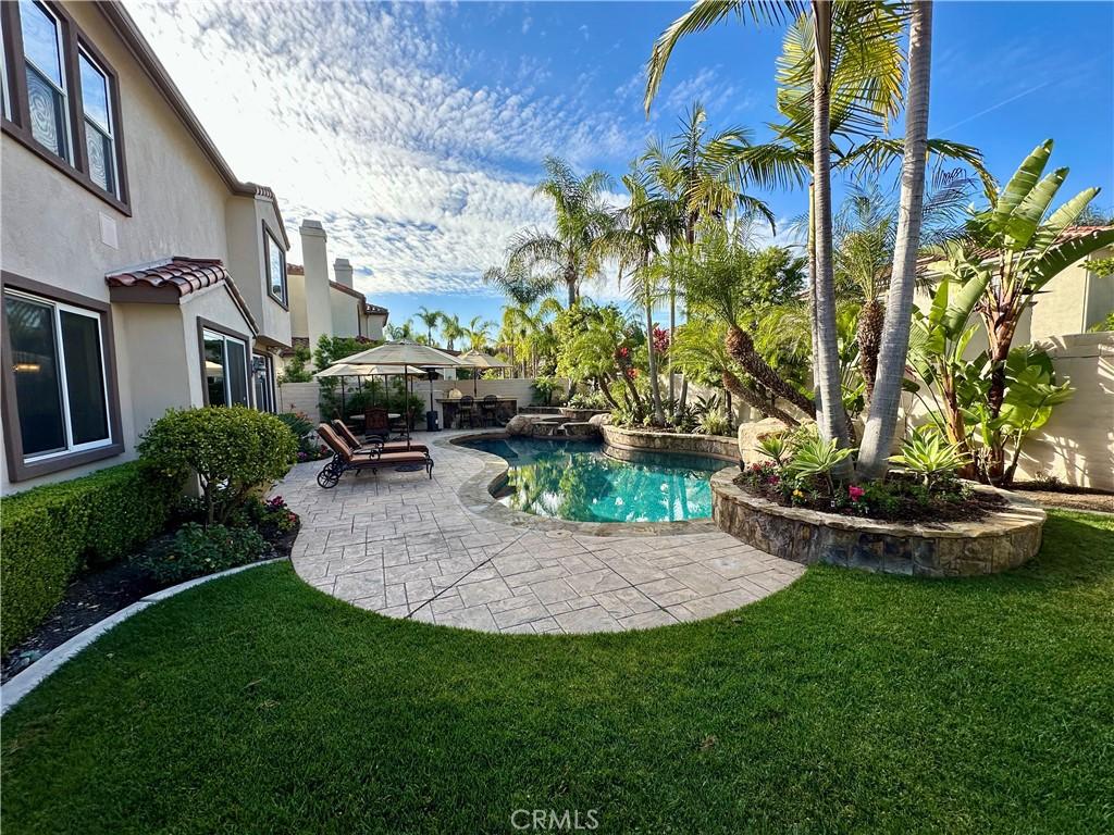 view of pool featuring a patio, a lawn, a fenced backyard, and a fenced in pool