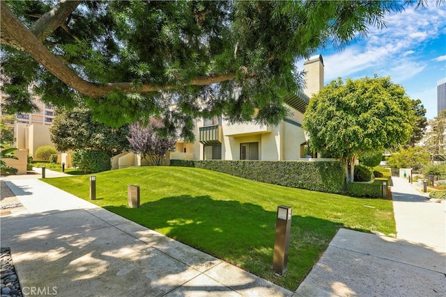 view of home's community featuring a lawn