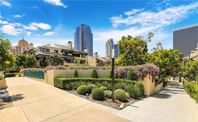 view of home's community with a view of city and fence