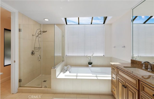 bathroom with a stall shower, vanity, and a bath