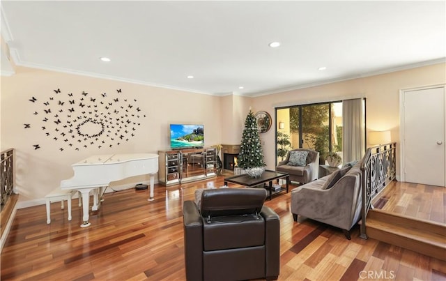 living area featuring recessed lighting, crown molding, baseboards, and wood finished floors