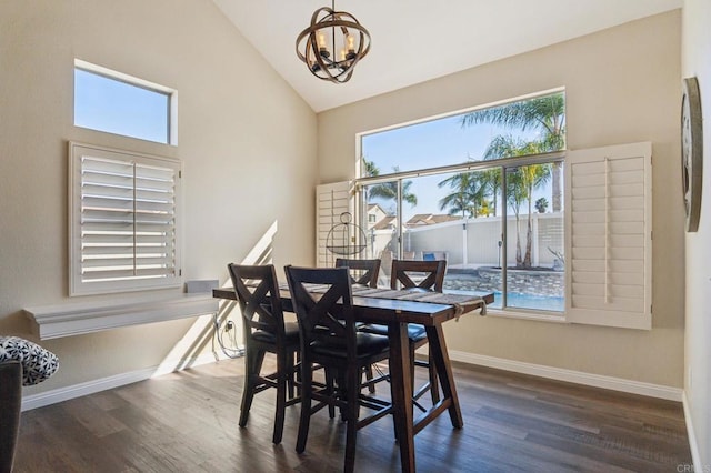 dining space featuring dark wood-type flooring, baseboards, and an inviting chandelier