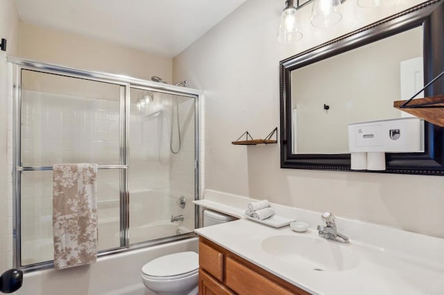 full bathroom with toilet, enclosed tub / shower combo, and vanity