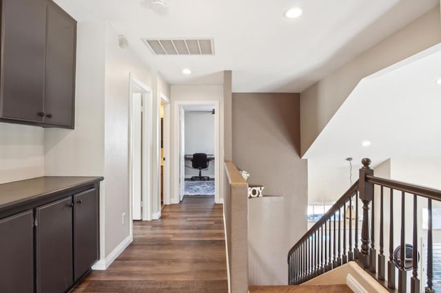 hallway featuring recessed lighting, an upstairs landing, baseboards, visible vents, and dark wood-style floors