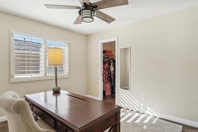 office with dark wood-style floors, ceiling fan, and baseboards