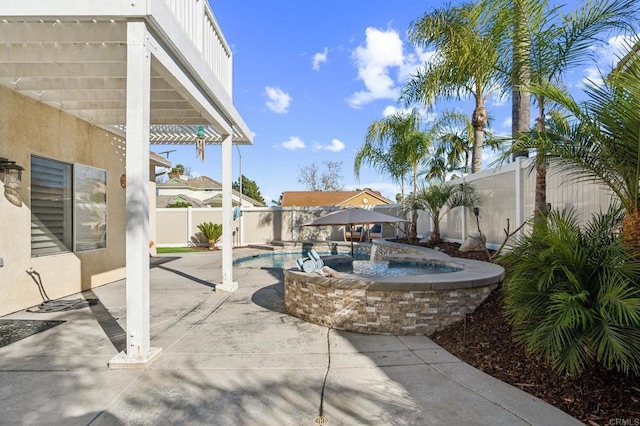 view of patio / terrace featuring an in ground hot tub, a fenced backyard, and a fenced in pool