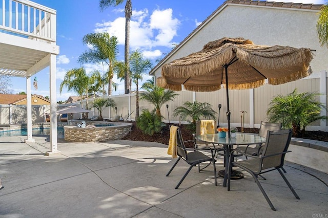 view of patio featuring a fenced in pool, a balcony, a fenced backyard, a jacuzzi, and outdoor dining space