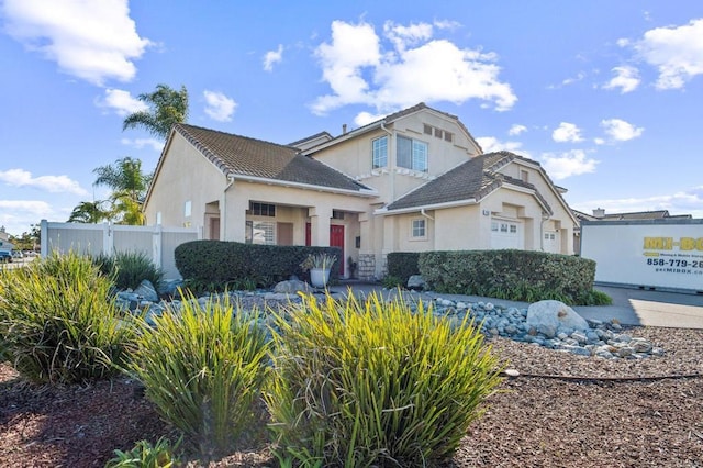 view of front of house featuring fence and stucco siding