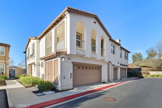 view of front of house with a garage and stucco siding