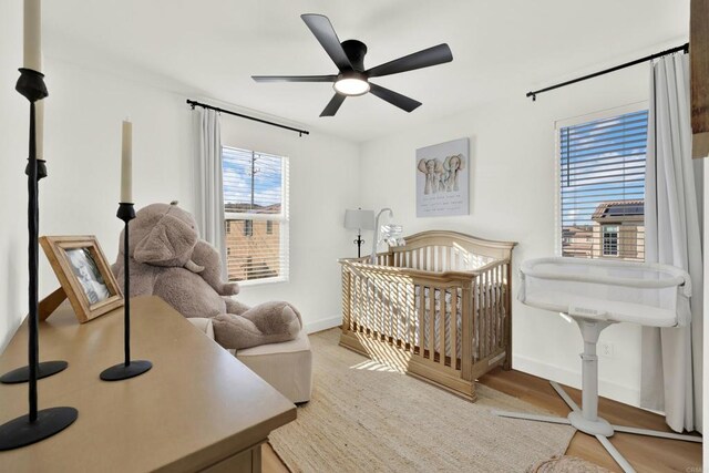 36540 Diego Springs Ave, Murrieta, CA 92563 - bedroom featuring baseboards, a ceiling fan, wood finished floors, and a crib