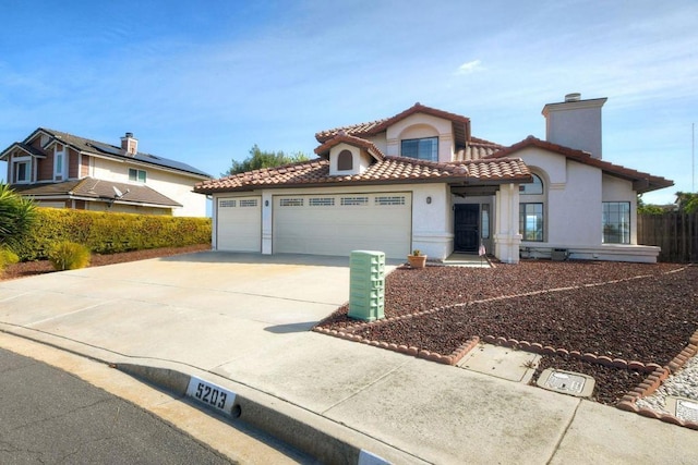 mediterranean / spanish-style home with a tile roof, a chimney, stucco siding, concrete driveway, and a garage