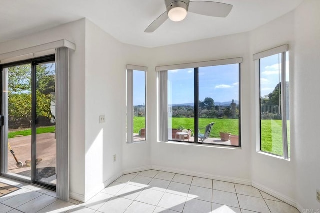 entryway with baseboards, light tile patterned flooring, and a healthy amount of sunlight