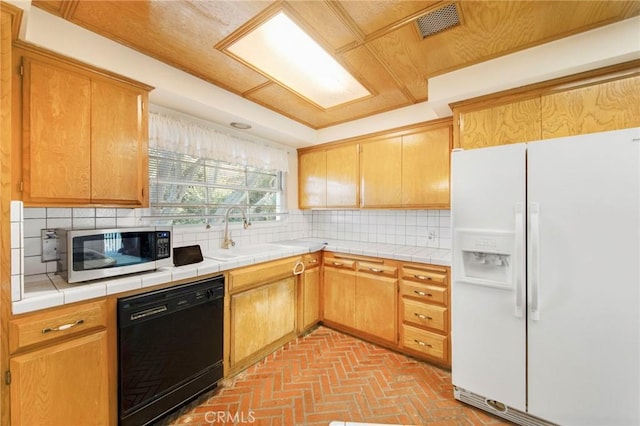 kitchen with tasteful backsplash, dishwasher, stainless steel microwave, white fridge with ice dispenser, and a sink