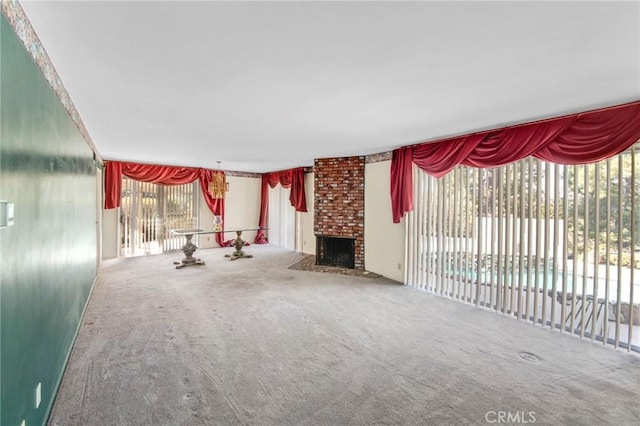 unfurnished living room featuring carpet floors and a fireplace