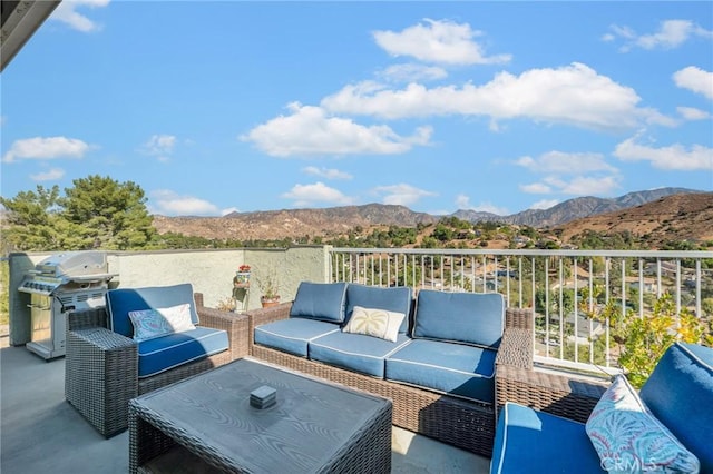 view of patio / terrace with a mountain view, an outdoor living space, and grilling area