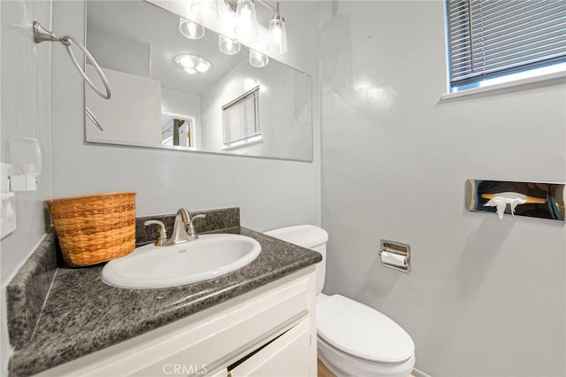 bathroom featuring toilet and vanity