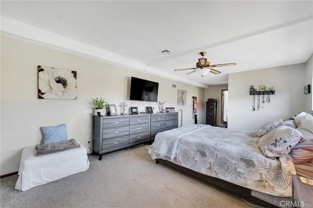 bedroom with a ceiling fan, visible vents, and light colored carpet