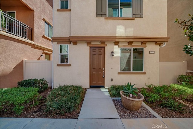 711 Banyan Way, Pomona, CA 91767 - doorway to property with fence and stucco siding