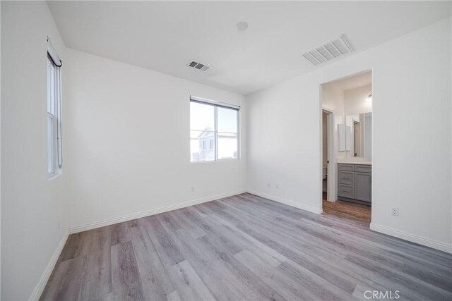 711 Banyan Way, Pomona, CA 91767 - unfurnished bedroom featuring light wood-type flooring, visible vents, and baseboards