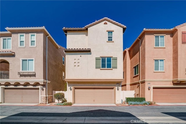 711 Banyan Way, Pomona, CA 91767 - view of front of house featuring a garage, a tile roof, and stucco siding
