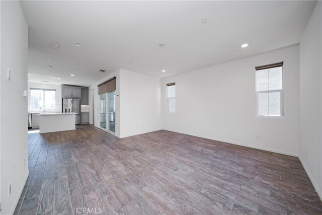 711 Banyan Way, Pomona, CA 91767 - unfurnished living room with baseboards, wood finished floors, and recessed lighting