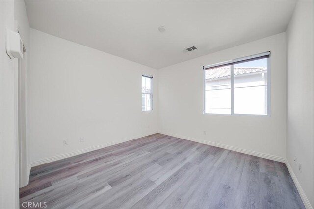 711 Banyan Way, Pomona, CA 91767 - empty room featuring light wood-type flooring, visible vents, and baseboards