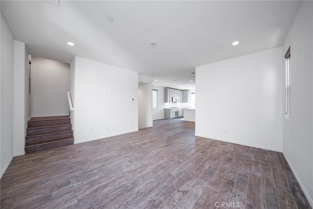 711 Banyan Way, Pomona, CA 91767 - unfurnished living room with stairs, dark wood-type flooring, baseboards, and recessed lighting
