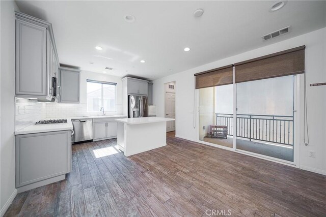 711 Banyan Way, Pomona, CA 91767 - kitchen featuring gray cabinetry, light countertops, stainless steel appliances, and a center island