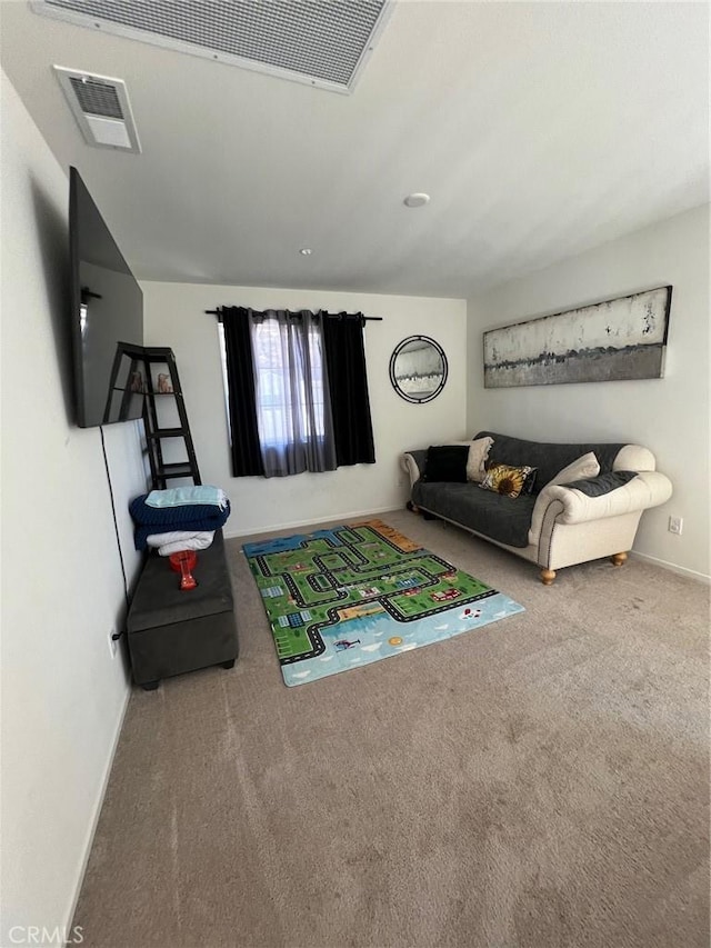 living area featuring carpet floors, visible vents, and baseboards