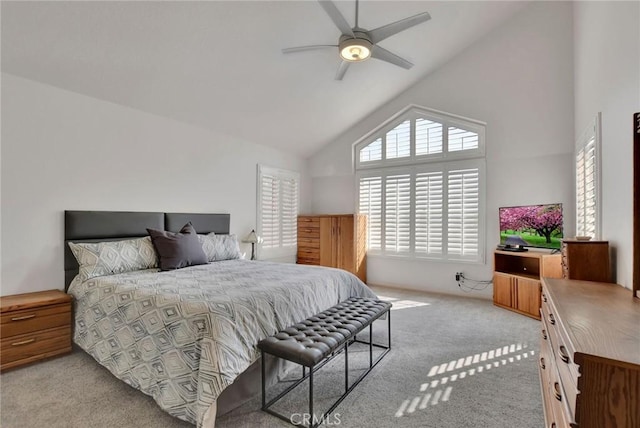 bedroom featuring high vaulted ceiling, a ceiling fan, and light colored carpet