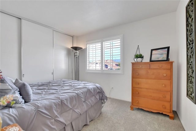 bedroom featuring a closet and light colored carpet