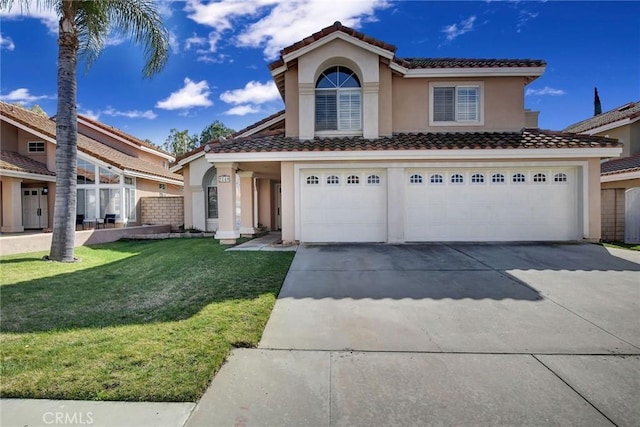 view of front of property featuring stucco siding, a garage, driveway, a tiled roof, and a front lawn