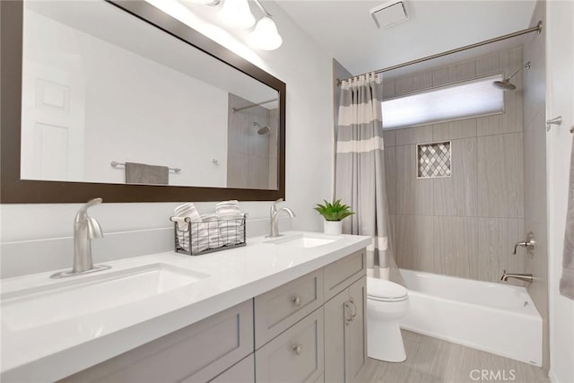 bathroom with shower / bath combination with curtain, a sink, toilet, and double vanity