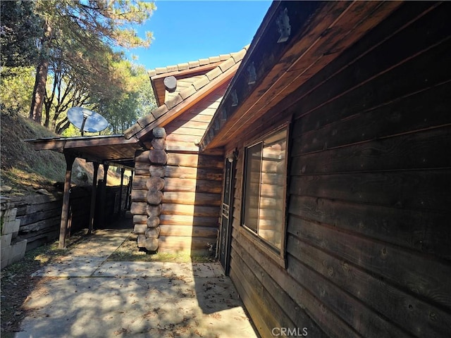 view of property exterior with a patio area