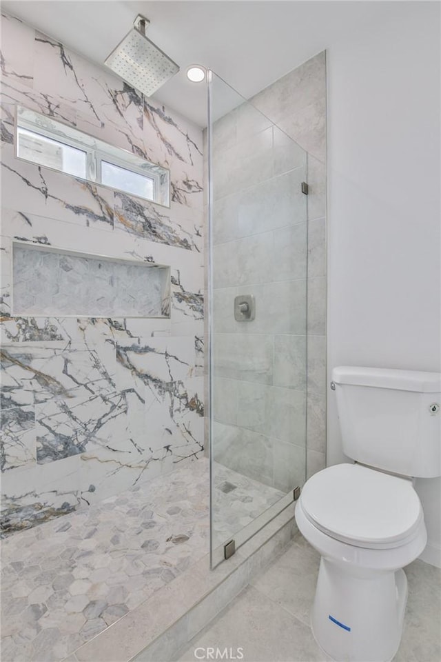 full bathroom featuring a shower stall and toilet