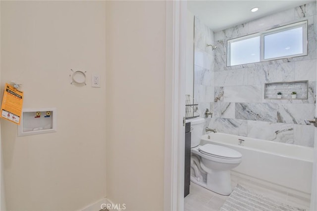 bathroom featuring shower / tub combination and toilet